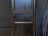 a tall black cabinet in the corner of a room