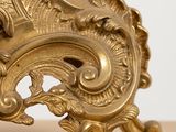 a gold clock that is sitting on a table