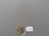 a close up of a necklace with a tag on a table