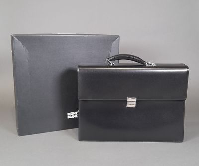 a black briefcase sitting next to a box on a table