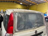 a car that has been covered with plastic in a garage