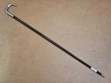 a close up of a cane on a table with a brown background