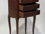 an image of a small wooden table with three drawers on it
