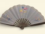 a fan with a design on it on a white surface