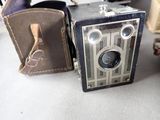 an old camera sitting on a table next to a case