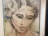 tableau représentant le visage d'une femme, dans un cadre noir sur fond blanc