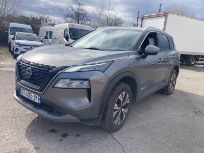 the grey nissan suv is parked in the parking lot