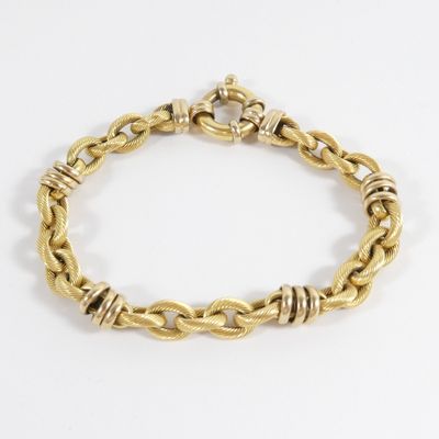 a close up of a gold bracelet on a white background