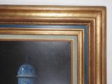 a painting of a blue and white vase in a gold frame