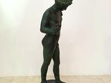 bronze statue of a man with a hat on his head