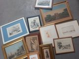 a lot of framed pictures on the floor next to a pair of shoes