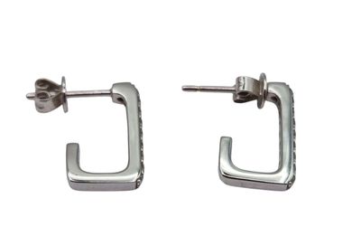 a pair of silver earrings with a square design on them