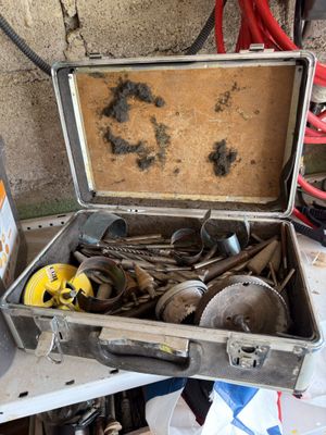 a suitcase with tools in it sitting on a table