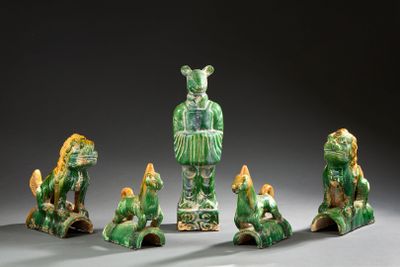 several figurines of animals and a man in a green dress