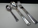 three spoons and two spoons sitting on a table