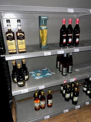 many bottles of alcohol on the shelves in the store