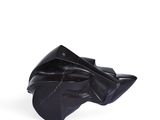 black leather shoe on a white surface with a white background