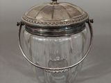 a glass jar with a metal lid on a table