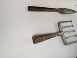 two old garden tools on a table next to each other