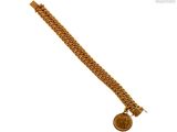 an image of a gold bracelet with a coin on it