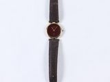 a close up of a watch on a white surface with a white background