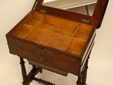 a small wooden table with a mirror on it