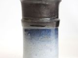a close up of a vase on a white surface