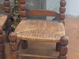 two wooden chairs sitting next to each other on the floor