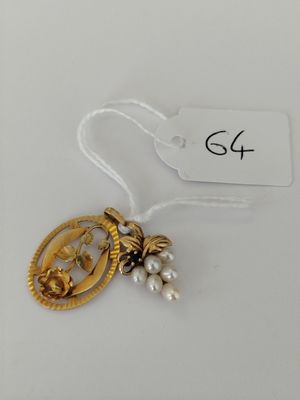 a close up of a gold and pearl necklace with a tag on it