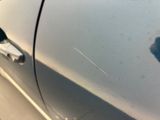 a close up of a car door handle with a shadow of a person on it