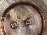 a close up of a metal plate with a number on it