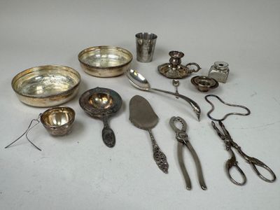 a lot of silverware on a table with scissors and spoons