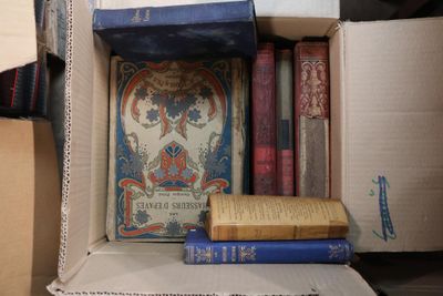 many books in a cardboard box on the table