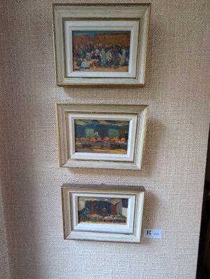 trois tableaux accrochés au mur au-dessus des toilettes