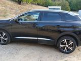 a black car that is parked on the side of the road