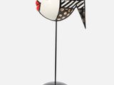 an image of a black and white fish figurine on a black base
