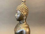 an image of a statue of a buddha sitting on a table