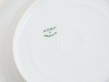 a close up of a white plate with green writing on it