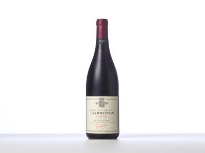 a bottle of red wine sitting on top of a table