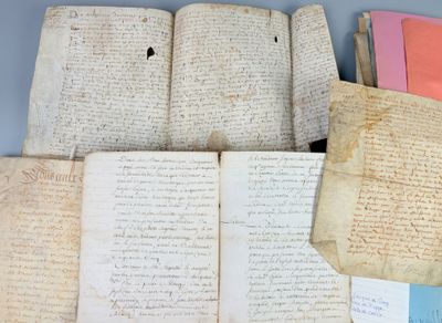 several old papers are stacked on top of each other on a table