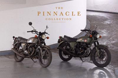 two motorcycles parked next to each other in a garage