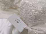 une robe de mariée blanche exposée, avec une étiquette de prix