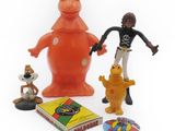 toy figurines of a man, a dog, a cat, and a frog