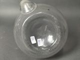 a clear glass vase with a small bird on it