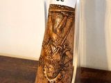 a wooden object on a clear stand on a wooden table