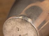a silver cup that is sitting on a table
