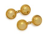 a pair of yellow gold cufflinks with a circular design