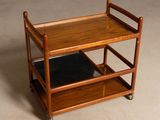 a small wooden cart with a black tray on it