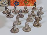 a lot of silver figurines that are on a table