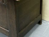 a small wooden chest with a drawer on top of it